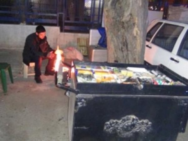 Tenekede Yaktığı Ateşle ısınıyor 
